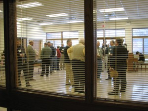 A group socializing in the multi-purpose room prior to the first presentation.